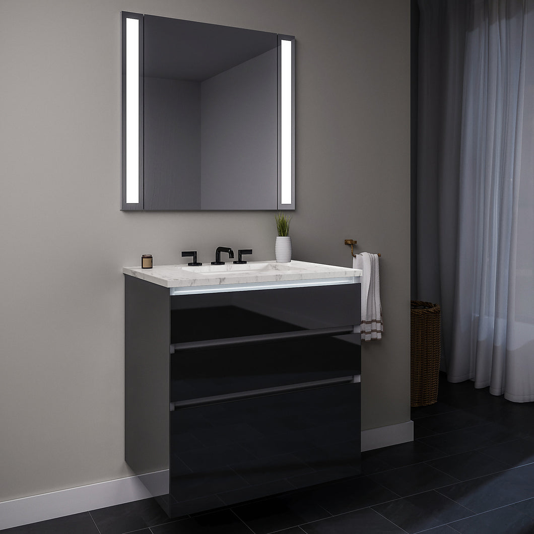 Curated Cartesian 24" x 7-1/2" x 21" and 24" x 15" x 21" three drawer vanity in tinted gray mirror glass with tip out drawer, slow-close plumbing drawer, full drawer, night light and Engineered Stone 25" vanity top in Silestone lyra